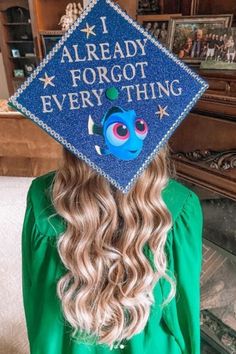 a girl wearing a blue graduation cap with the words i already forgot everything on it