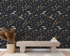 a wooden bench sitting in front of a wallpaper with flowers and birds on it