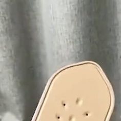 a toaster sitting on top of a table next to a wall with holes in it