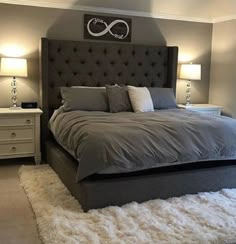 a large bed sitting in the middle of a bedroom next to two lamps on either side of it