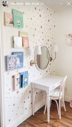 a white desk and chair in a room with stars on the wall behind it,