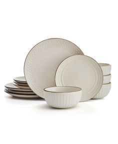 a set of white dishes with black rims