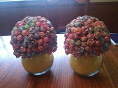 two vases filled with candy sitting on top of a wooden table