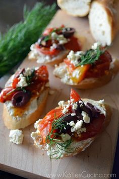 breads with different toppings are on a cutting board