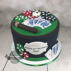 a birthday cake decorated with playing cards and dice