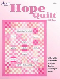 a pink and white checkered quilt with words written on the front in cursive writing