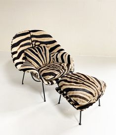 a zebra print chair and footstool are on display