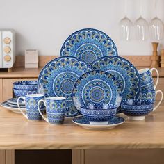 a blue and white dinner set on a wooden table