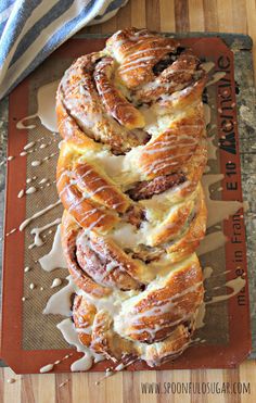 a bunch of cinnamon rolls sitting on top of a cutting board