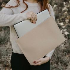 a woman holding a laptop computer in her hands