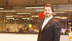 a man is standing in front of a glass wall with the canadian flag on it