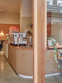 a coffee shop with people sitting at the counter