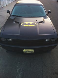 the batman car is parked on the side of the road