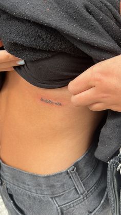 a woman with a small tattoo on her stomach