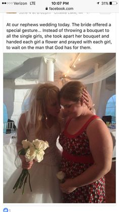 two women are hugging each other in front of a white tent with flowers on it