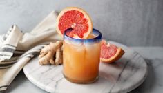 two grapefruit cocktails on a marble platter