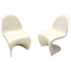 two white chairs sitting next to each other