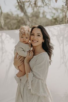 a woman holding a baby in her arms