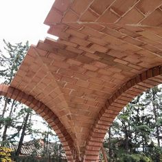 a large brick structure sitting in the middle of a forest