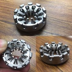 there are three different types of gears on the table and one is being held up by a finger