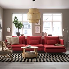 a living room with red couches and black and white checkered rug on the floor