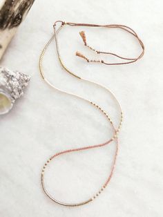 This delicately-strung exclusively crafted necklace has a mix of 14k Gold 2mm beads and tiny Japanese Miyuki glass beads in Peach Silk, translucent silver, cream and shiny gold. All beads have different finishes with a mix of shiny satin and matte cream. It is finished with a gold filled sliding clasp to adjust to your size. Wear this alone or layer and stack with other beaded tones for a fun yet elegant look. A great beach holiday essential that goes with everything. Treat yourself or spoil someone special! All items come carefully packaged in pretty sparkly tissue paper and a small jute bag with seaside charm. A white logo'd gift box is available for a small additional cost. Please select from variations. Why not browse our shop and take a look at our other listings. www.etsy.com/uk/shop Minimalist Single Strand Beaded Necklace, Minimalist Gold Beaded Necklace For Everyday, Minimalist Beaded Necklace With Delicate Adjustable Chain, Minimalist Adjustable Beaded Necklace With Delicate Chain, Delicate Adjustable Beaded Necklace With Tiny Beads, Delicate Everyday Beaded Necklace With Tiny Beads, Adjustable Lariat Necklace With Tiny Beads, Adjustable Tiny Beads Lariat Necklace, Delicate Adjustable Single Strand Beaded Necklaces