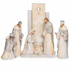 the nativity figurines are all dressed in white