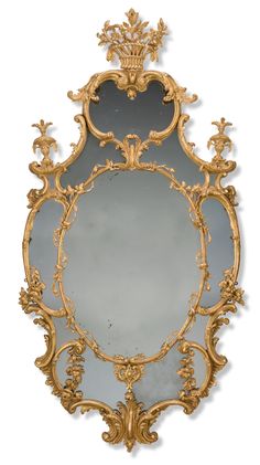 an ornately decorated mirror with gold trim