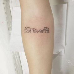 a woman's arm with elephants on it and the word elephant written in black ink