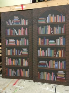 two large bookshelves are made out of wood and painted with different colors on them