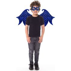 a young boy wearing a blue mask with wings on his head, standing in front of a white background