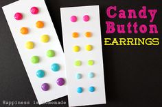 two candy button earrings sitting on top of a white card with the words candy button earrings