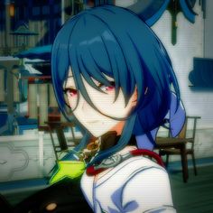 an anime character with blue hair holding a green object in her hand and looking at the camera