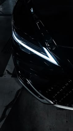 the front end of a black sports car