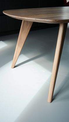 a wooden table sitting on top of a white floor