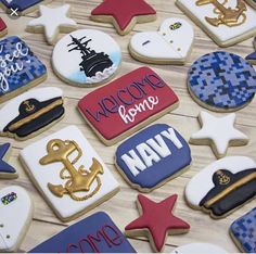 decorated cookies are arranged on a table with the words welcome home and navy written on them