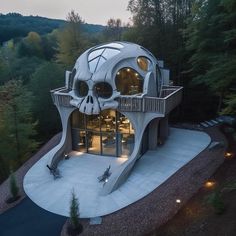 an unusual house in the middle of trees