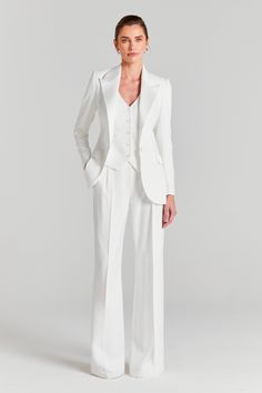 a woman in a white suit and heels