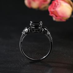 Sparkling and luxurious, this skull ring will capture your heart at first sight. Crafted in sterling silver, with two skulls both sides and a black round cut stone on the top. Perfect fit for engagement or wedding occasion. Simple design make it very comfortable and convenient for wearing everyday. She'll instantly fall in love with this design.Carat Weight: 3.9 ctStone Size: 1.5,1.2,1.0,0.8,8*8 mmNumber of Stones: 37 Stone Shape: Round, CushionStone Color: Fancy BlackWeight: 3.37 gWidth: 2.26 m Gothic Black Rings With Skull Print, Black Skull Rings As Gift, Black Skull Rings For Gift, Black Skull Ring For Halloween, Gothic Skull Open Ring Gift, Black Skull Print Ring, Halloween Black Skull Ring, Black Sterling Silver Skull Ring, Gothic Black Skull Ring For Halloween