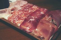 several different types of meats on a cutting board