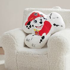 a stuffed dog sitting on top of a white chair