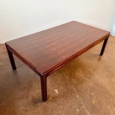 a wooden table sitting on top of a dirty floor