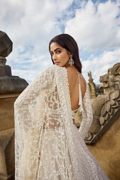 This ivory lehenga set features intricate embroidery in thread, pearl and sequin in a linear pattern. The full sleeves blouse shows exaggerated tassels at the wrist. The dupatta has four sided heavy embroidery with a jaal in the centre.From Seema Gujral's A Royal Affair collection. DELIVERY TIMEPlease allow 8-12 weeks for your outfit to arrive. FABRIC DETAILSNet Professional cleaning only. Indo Western Gowns Indian Weddings, Long Sleeve Lehenga, Ivory Lengha, Aria Outfits, Pearl Lehenga, American Indian Dress, Sangeet Dress, White Bridal Lehenga, Full Sleeves Blouse