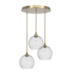 three clear glass globes hanging from a brass ceiling fixture with two lights on each side