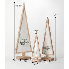 two wooden christmas trees are shown with measurements