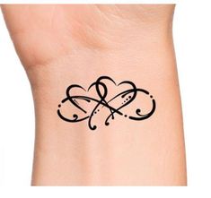 a small tattoo on the wrist of a woman's left arm, with an intertwined