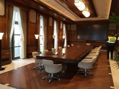 an empty conference room with chairs and a projection screen in the middle of the room