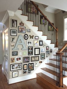 a staircase with many pictures on the wall