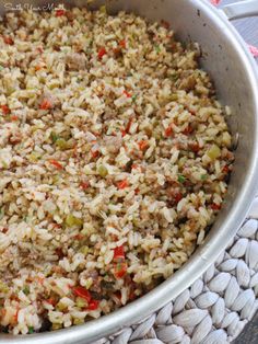 a bowl filled with rice and vegetables on top of a table