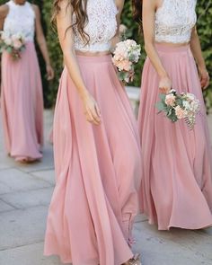 three bridesmaids in pink dresses walking down the street